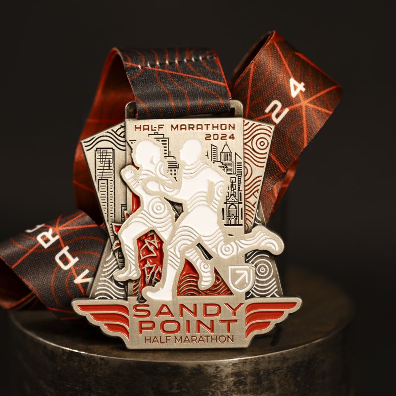 Sandy Point Half Marathon custom event medal with antique silver finish. The marathon's logo is coloured in with enamel.