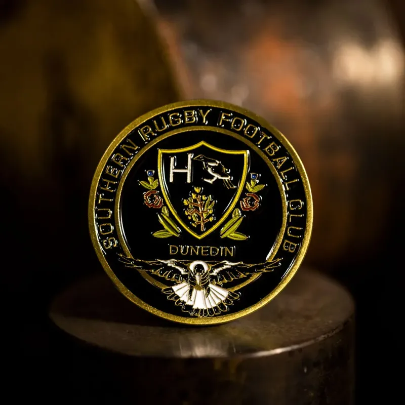 Custom Southern Rugby Football Club challenge coin in antique gold finish, with the club's logo in the centre. The logo is coloured with enamel.