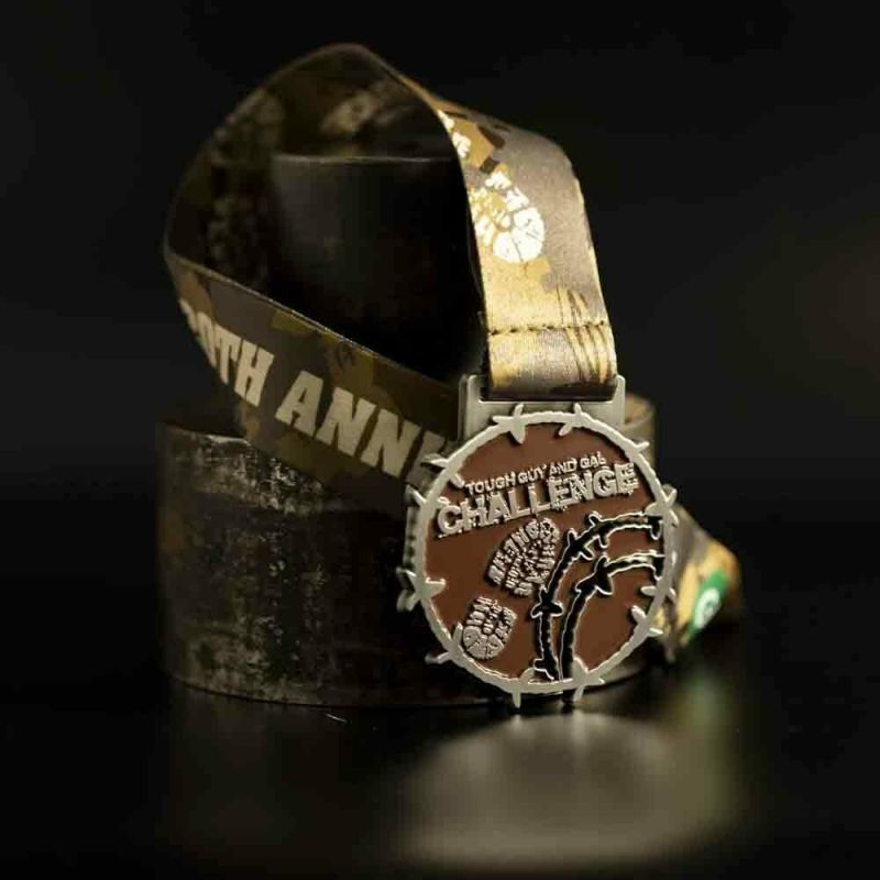 Metal Tough Guy And Gal Challenge custom event medal with an antique silver finish. The event's logo is coloured in with enamel. The medal is a custom shape and features cut-outs.