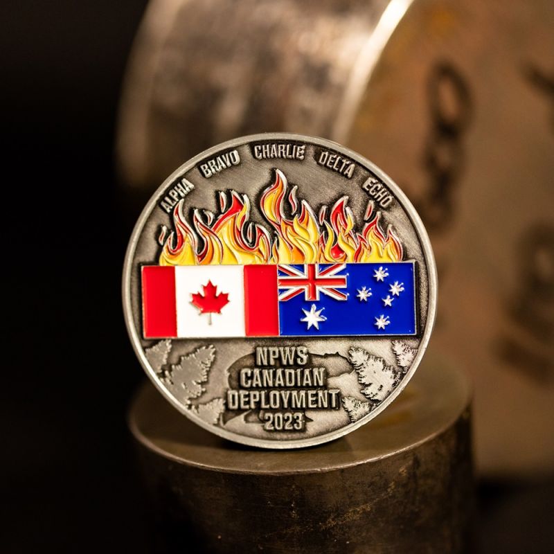 Custom NSW National Park And Wildlife Service challenge coin in antique silver finish, with a custom design in the centre. The logo is coloured with enamel. 