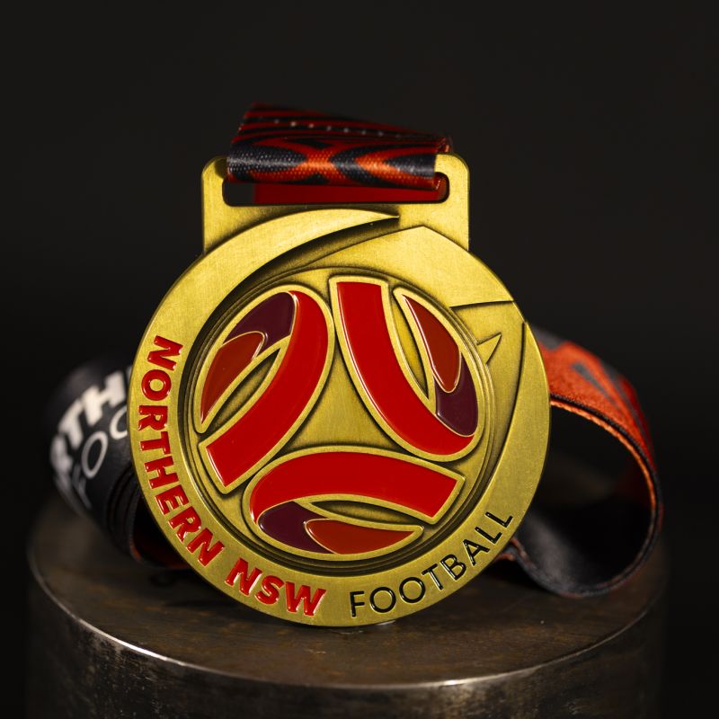 Northern NSW Football custom event medal with antique gold finish.