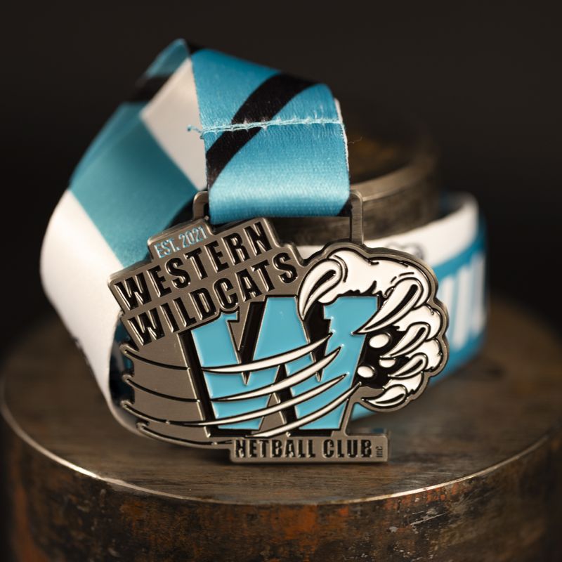 Western Wildcats Netball Club custom event medal with antique gold finish.