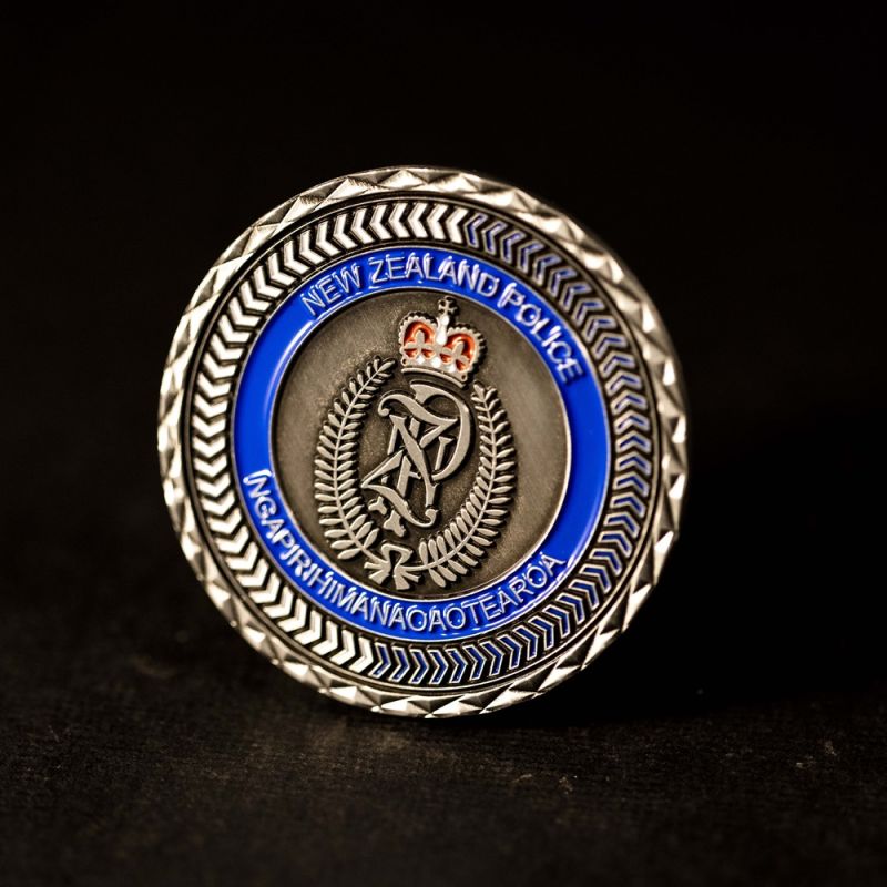 Custom Otautahi Christchurch challenge coin in antique gold finish, with the club's logo in the centre. The logo is coloured with enamel and is 3D.