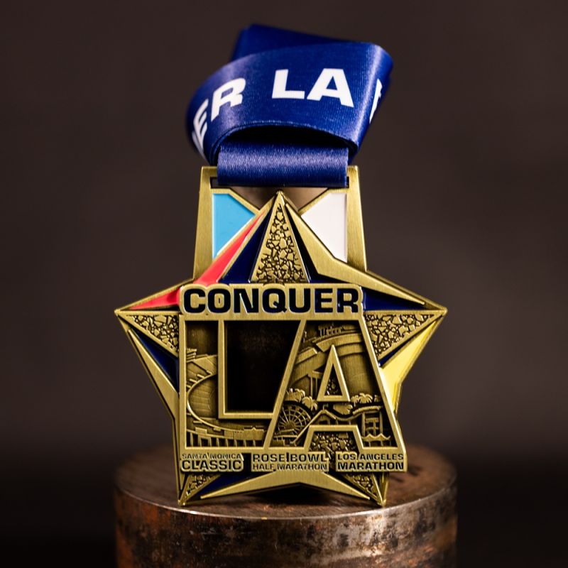 Metal Nike Melbourne Marathon custom event medal with antique gold finish. The marathon's logo is coloured in with enamel. The medal features a cut out that doubles as a bottle opener in its centre. 