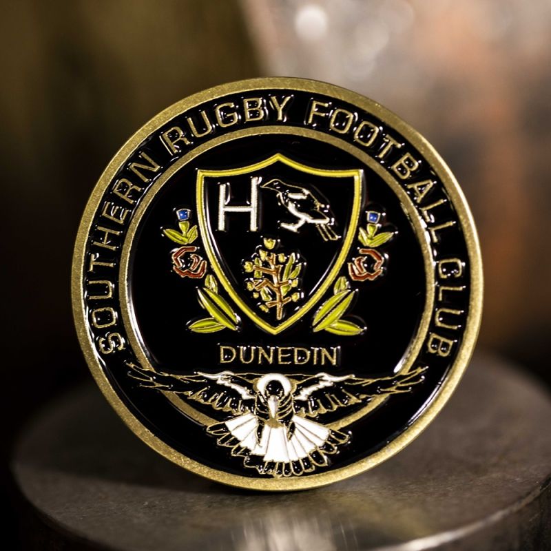 Custom Southern Rugby Football Club challenge coin in antique gold finish, with the club's logo in the centre. The logo is coloured with enamel.