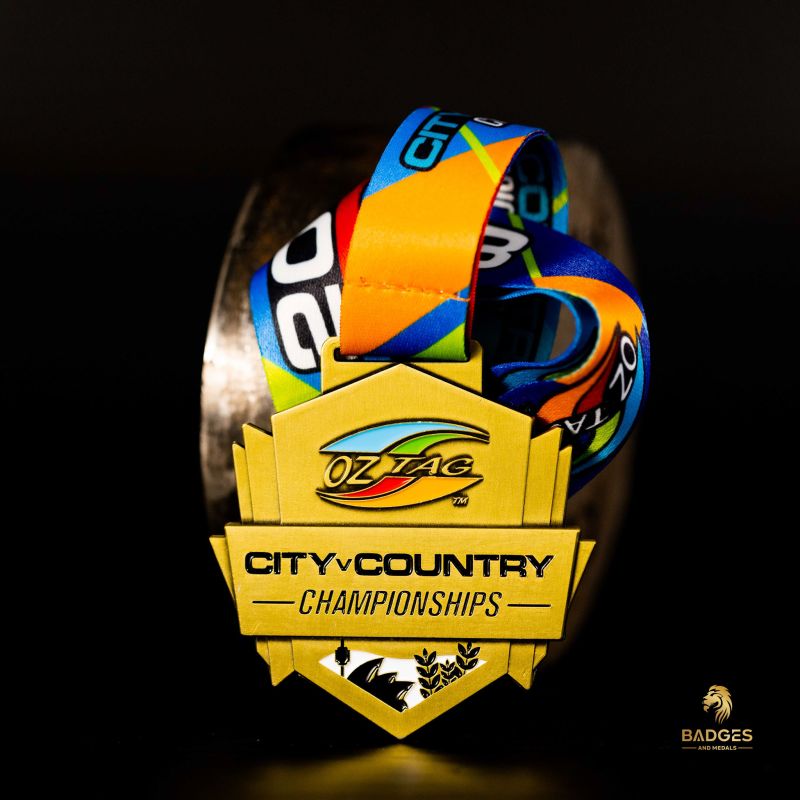 Metal OzTag 'City V Country' custom event medal with an antique gold finish. The event's logo is coloured in with enamel. 
