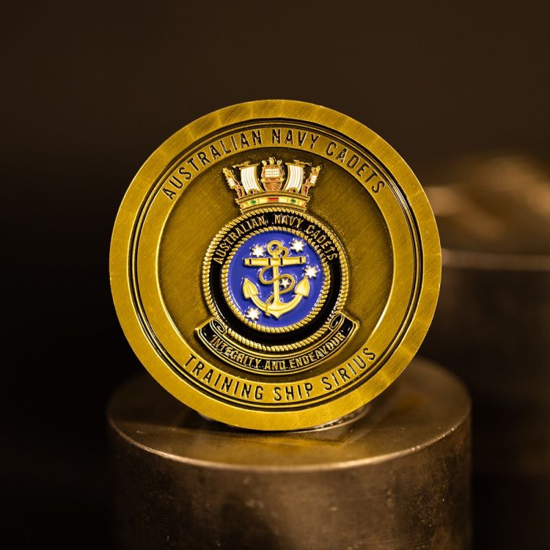 Custom Southern Rugby Football Club challenge coin in antique gold finish, with the club's logo in the centre. The logo is coloured with enamel.