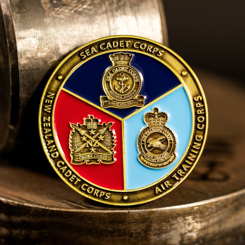 Custom Auckland Fire Brigade Museum challenge coin in antique silver finish, with a custom design in the centre. The logo is coloured with enamel. 