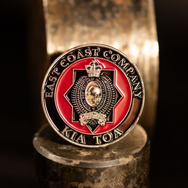 Custom Otautahi Christchurch challenge coin in antique gold finish, with the club's logo in the centre. The logo is coloured with enamel and is 3D.