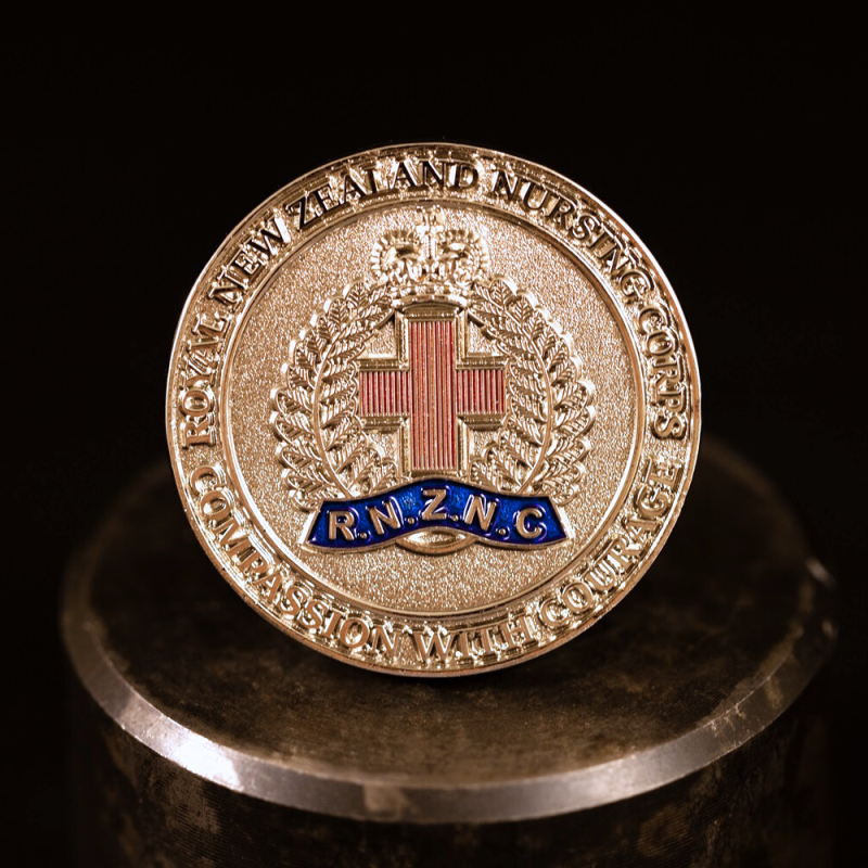 Custom New Zealand Army 'Regular Force Cadet' challenge coin in antique silver finish, with a custom design in the centre. The logo is coloured with enamel. 