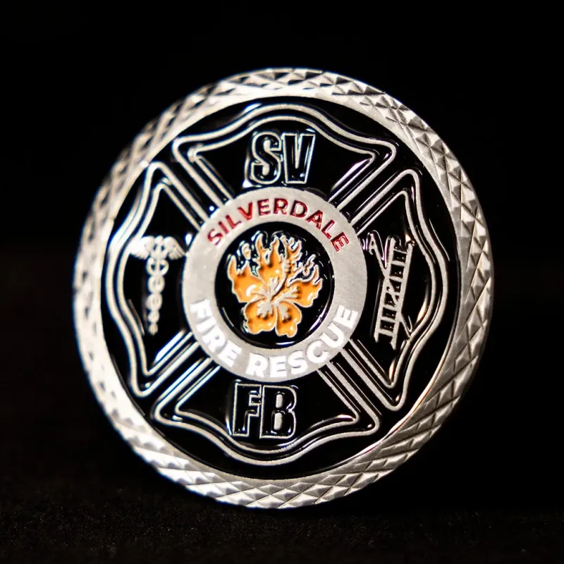 Custom Silverdale Fire Brigade challenge coin in antique silver finish, with the unit's logo in the centre. The logo is coloured with enamel. The edge of the coin has cut-crosslines.