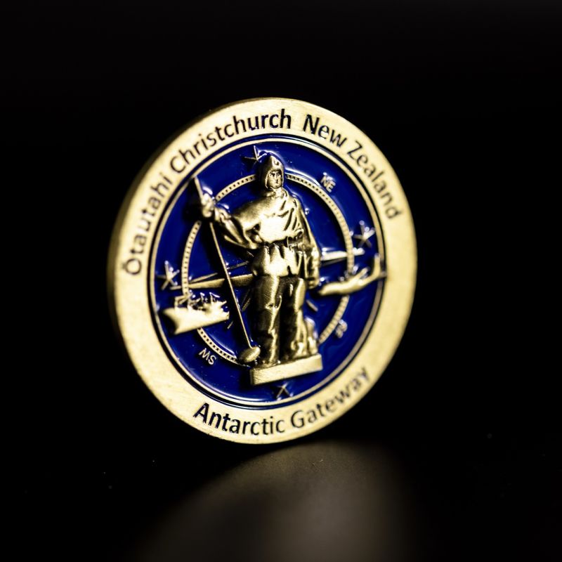 Custom Otautahi Christchurch challenge coin in antique gold finish, with the club's logo in the centre. The logo is coloured with enamel and is 3D.